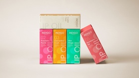 Modern packaging design for "Indigo Lip Oil," featuring bold colors and clean typography. Each variant stands out with its unique color palette.
