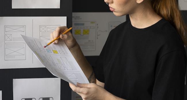 A UX designer determining the scope of a project to determine cost.